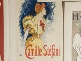many different posters on the wall of a room