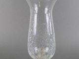 an old fashioned glass vase sitting on top of a table