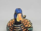 an image of a small wooden duck sitting on top of a table