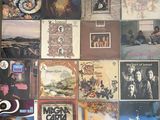 many different album covers on the wall of this room