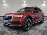 a red audi qx parked in a showroom