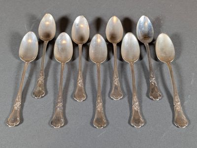 six spoons are lined up in a row on a table