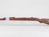a rifle with a wooden barrel on a white background