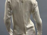 an image of a mannequin wearing a white shirt and gray pants