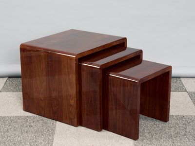 three wooden nesting tables sitting on top of a checkered floor