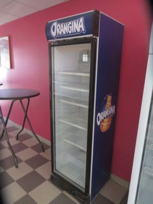 a refrigerator that is sitting in the corner of a room