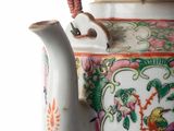 a tea pot with a handle on a table