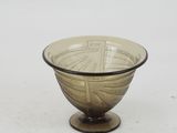 a glass bowl with a design on it on a table