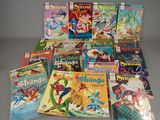 many comics are stacked on top of each other on a table