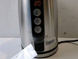 a toaster that is sitting on a table with a price tag attached to it