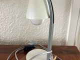 a lamp that is on a table with a plate on it