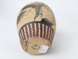 a vase with a painting on it on a white surface