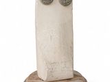 sculpture of a face on a marble base with two eyes