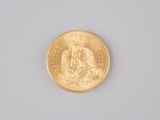 an image of a close up of a gold coin on a white surface