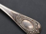 silver spoon on a black surface with a silver colored handle