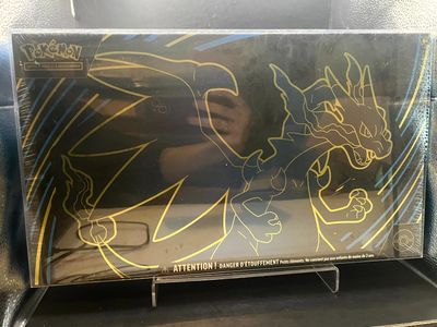 someone is drawing on the back of a box of pokemon trading cards