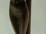 a statue of a woman that is standing on a pole
