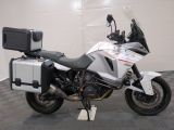 a motorcycle parked in a garage with a box on the back of it