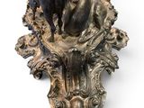 a bronze sculpture of a deer and a bird on a pedestal