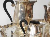 a silver tray with a silver tea set on it
