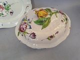 two plates with flowers painted on them on a table