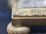a close up of a silver object on a blue surface