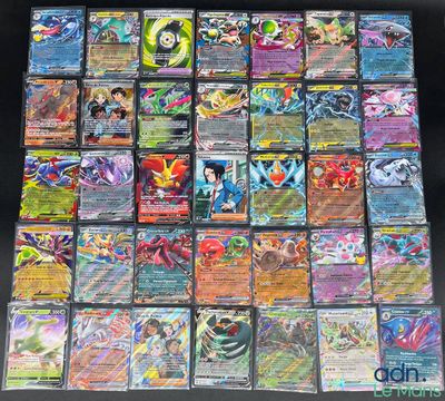 a large collection of pokemon cards sitting on top of a table