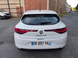 the rear end of a white car parked in a parking lot