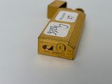 a small gold lighter that is sitting on a table