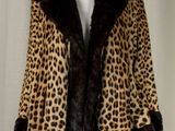 a picture of a leopard print coat on a mannequin