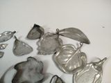 several pieces of silver are sitting on a white surface
