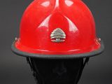 a close up of a red fireman ' s helmet on a mannequin head