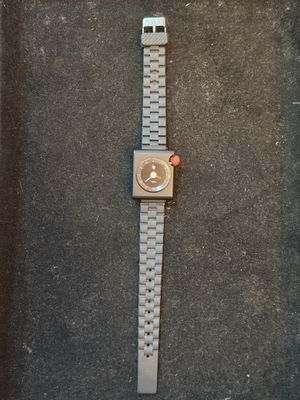 the watch is laying on the floor next to the wall