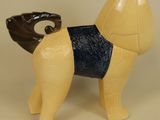 a toy dog that is standing on a white surface