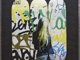 three skateboards that are painted with graffiti on them