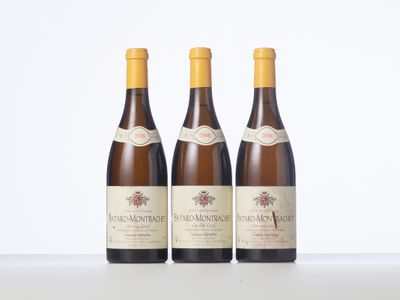 three bottles of wine sitting on top of a white table