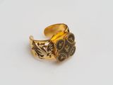 a close up of a gold ring on a white surface