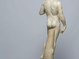 marble statue of a man holding a tennis racquet on a marble pedestal