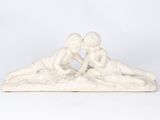 white marble sculpture of a couple kissing on the beach