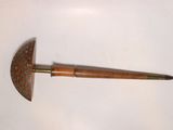 a wooden stick with a metal handle on a white surface