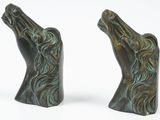 pair of bronze horse head bookends on a white background