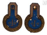 pair of blue and gold military badges with gold trims