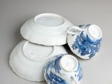 three cups and a saucer sitting on a table
