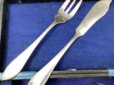two forks and two spoons in a blue box
