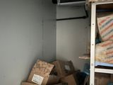 many boxes and boxes stacked on a shelf in a room