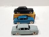 three toy cars sitting next to each other on a table