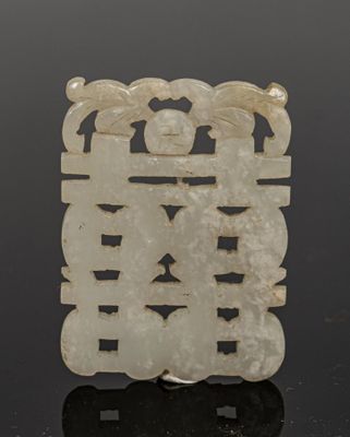an image of a white jade plaque with a design on it