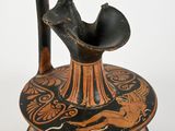 a black and orange vase with a bird on it