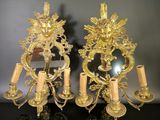 pair of gold plated wall sconces with flowers and candles
