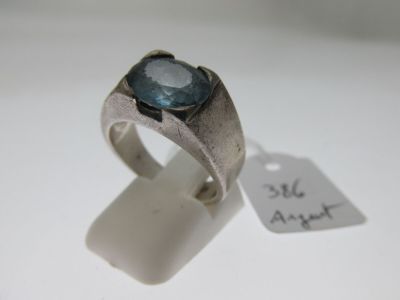a silver ring with a blue stone on it